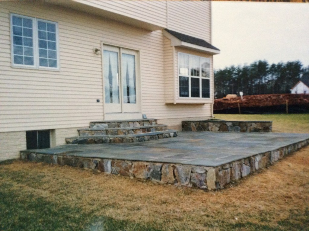 raised flagstone backyard patio by capital masonry