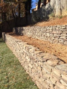 Terraced stacked stone retainer walls by Capital Masonry